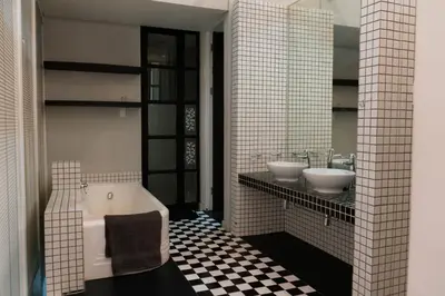 a bathroom with two sinks and a bath tub at See You There Accommodation in Centurion