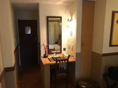 a small room with a desk and a mirror at De Oude Herberg in Centurion