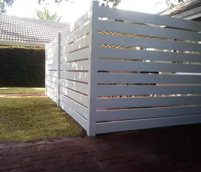a white fence in front of a yard at Willows Garden Studio in Pretoria