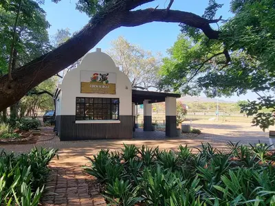 a small building with a sign on it at Cock & Bull Restaurant - Pub - Accommodation in Hartbeespoort