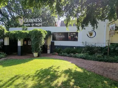 a building with a sign on the side of it at Cock & Bull Restaurant - Pub - Accommodation in Hartbeespoort
