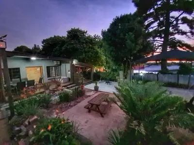 a backyard with a wooden bench in the yard at The Elements in Graskop