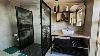 a bathroom with a shower and a sink at The Elements in Graskop