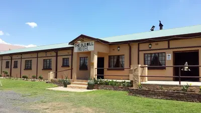 a building with a sign that reads hospital hotel at The Old Mill Hotel in Machadodorp