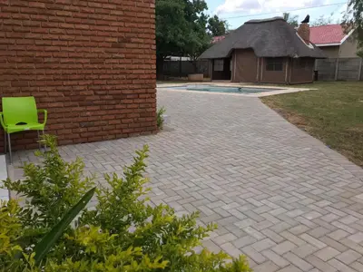 a brick yard with a green chair and a building at 4 on Sirius in Polokwane