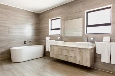 a bathroom with two sinks and a tub and mirrors at Sagwadi Hotel in Hazyview