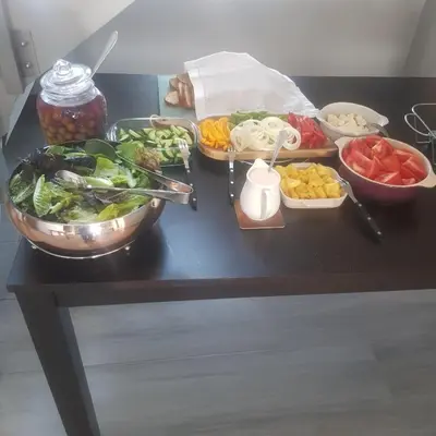 a table topped with bowls of vegetables and other foods at Sagwadi Hotel in Hazyview