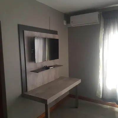 a room with a bench with a tv on the wall at Sagwadi Hotel in Hazyview