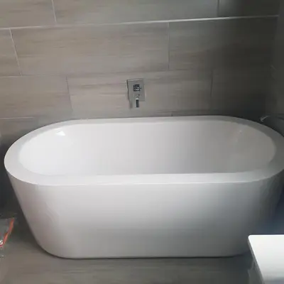 a white bath tub sitting in a bathroom at Sagwadi Hotel in Hazyview