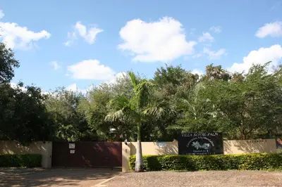 a sign for the teddy bear park with a palm tree at Villa Royal Palm in Komatipoort