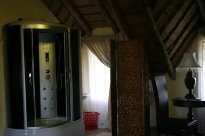 a room with a large mirror and a window at Villa Royal Palm in Komatipoort
