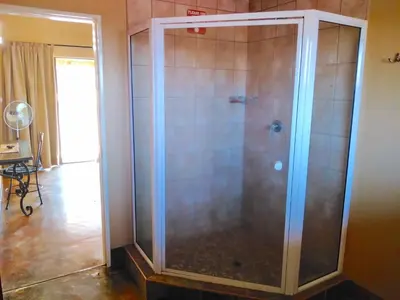 a shower with a glass door in a room at Zebula Luxury Lodge in Mabula