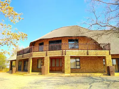 a brick building with a balcony on top of it at Zebula Luxury Lodge in Mabula