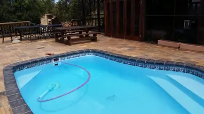a large blue swimming pool with a picnic table at Hadeda Lodge, Mabalingwe in Warmbaths