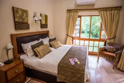 a bedroom with a large bed and a window at Kruger Park Lodge, Kubu Lodge 224 in Hazyview
