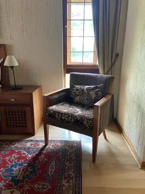 a chair in a room with a table and a window at Kruger Park Lodge, Kubu Lodge 224 in Hazyview