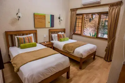 a hotel room with two beds and a window at Kruger Park Lodge, Kubu Lodge 224 in Hazyview