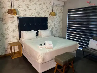 a bedroom with a large bed with two towels on it at ANISA GUESTHOUSE in Thohoyandou