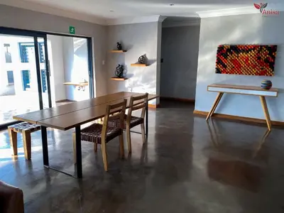 a dining room with a wooden table and chairs at ANISA GUESTHOUSE in Thohoyandou