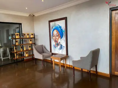 a room with two chairs and a painting on the wall at ANISA GUESTHOUSE in Thohoyandou