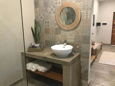 a bathroom with a sink and a mirror at Lowveld Living Guesthouse in Nelspruit