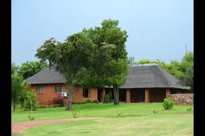 a house with a tree in front of it at Mothopo Game Lodge in Modimolle