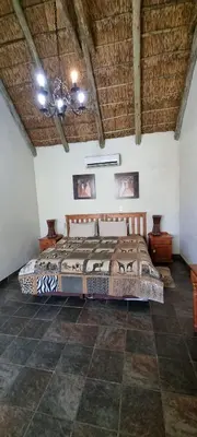 a bedroom with a bed in a room with a ceiling at Mothopo Game Lodge in Modimolle