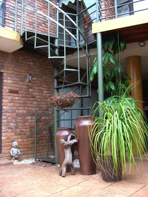 a statue of a animal standing in front of a building at Francor Guesthouse in Pretoria