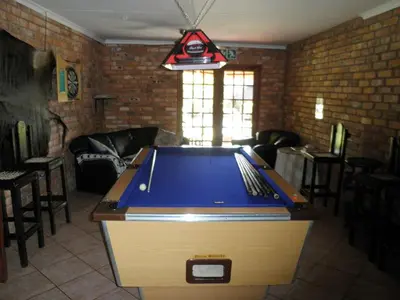 a ping pong table in a living room at Francor Guesthouse in Pretoria