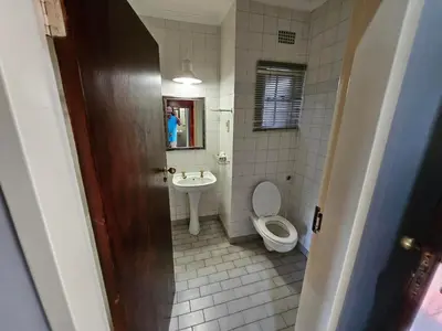 a bathroom with a toilet and a sink at Pietersburg Club in Polokwane