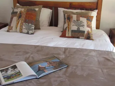 a book laying on top of a bed at Swiblati Lodge in Hoedspruit