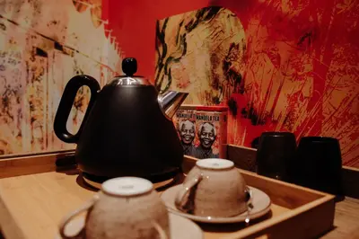 a black tea kettle sitting on a wooden table at Bastion House in Irene