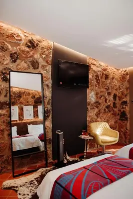 a bedroom with a mirror and a bed and a chair at Bastion House in Irene
