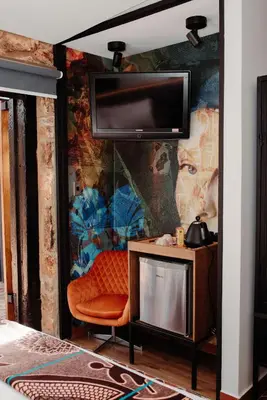 a room with a wall with a tv and a chair at Bastion House in Irene