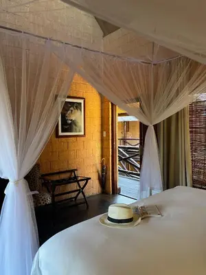 a bedroom with a bed with a hat on it at Zwahili Private Game Lodge & Spa in Modimolle