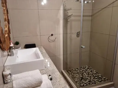 a bathroom with a sink and a shower at Casabac in Pretoria