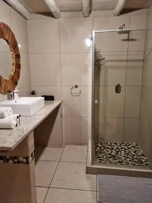 a bathroom with a shower and a sink at Casabac in Pretoria