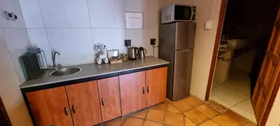 a small kitchen with a sink and a refrigerator at Casabac in Pretoria