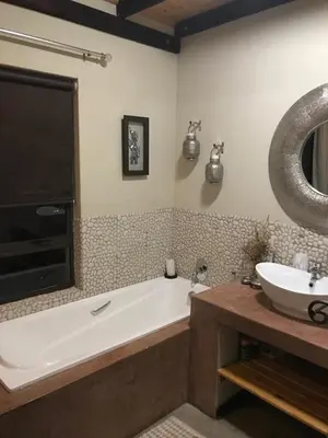 a bathroom with a bath tub and a sink at Twenty Four Mabalingwe Nature Reserve in Mabula