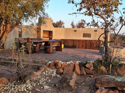 a house with a picnic table in front of it at Twenty Four Mabalingwe Nature Reserve in Mabula