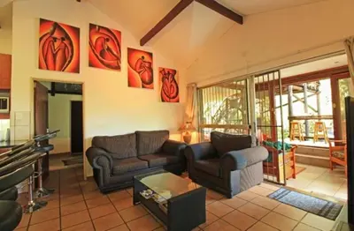 a living room with two couches and a table at Peace@Kruger in Marloth Park