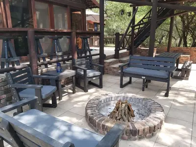 a group of benches sitting around a fire pit at Peace@Kruger in Marloth Park