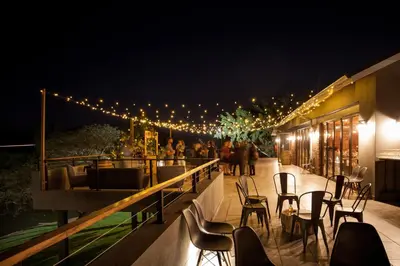 a patio with chairs and lights at night at Letaba Junction Lodge in Letsitele