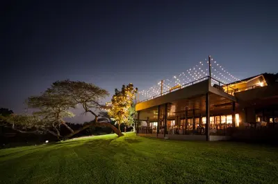 a building with lights on it at night at Letaba Junction Lodge in Letsitele
