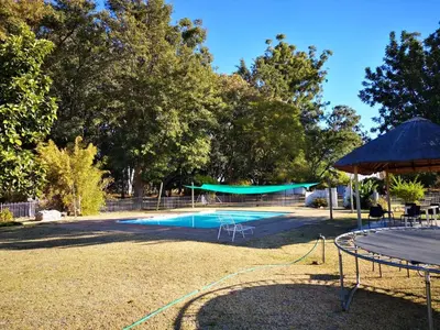 a large swimming pool with a gazebo at Aruka in Bela-Bela