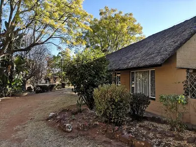 a house on the side of a dirt road at Aruka in Bela-Bela