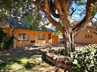 a house with a tree in front of it at Aruka in Bela-Bela