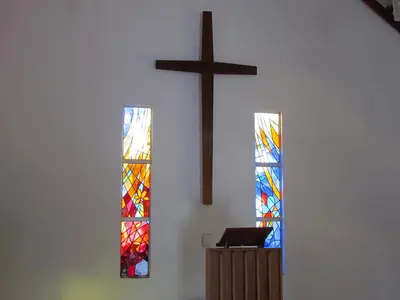 three stained glass windows in a church with a cross at Aruka in Bela-Bela
