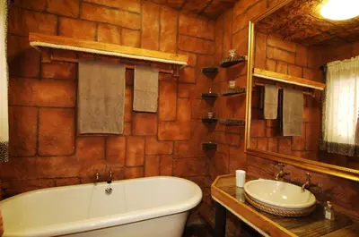 a bathroom with a bath tub and a sink at Kaia Tani Exclusive Guesthouse in Phalaborwa