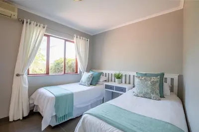 a bedroom with two beds and a window at Greenwaywoods Unit 11 in White River
